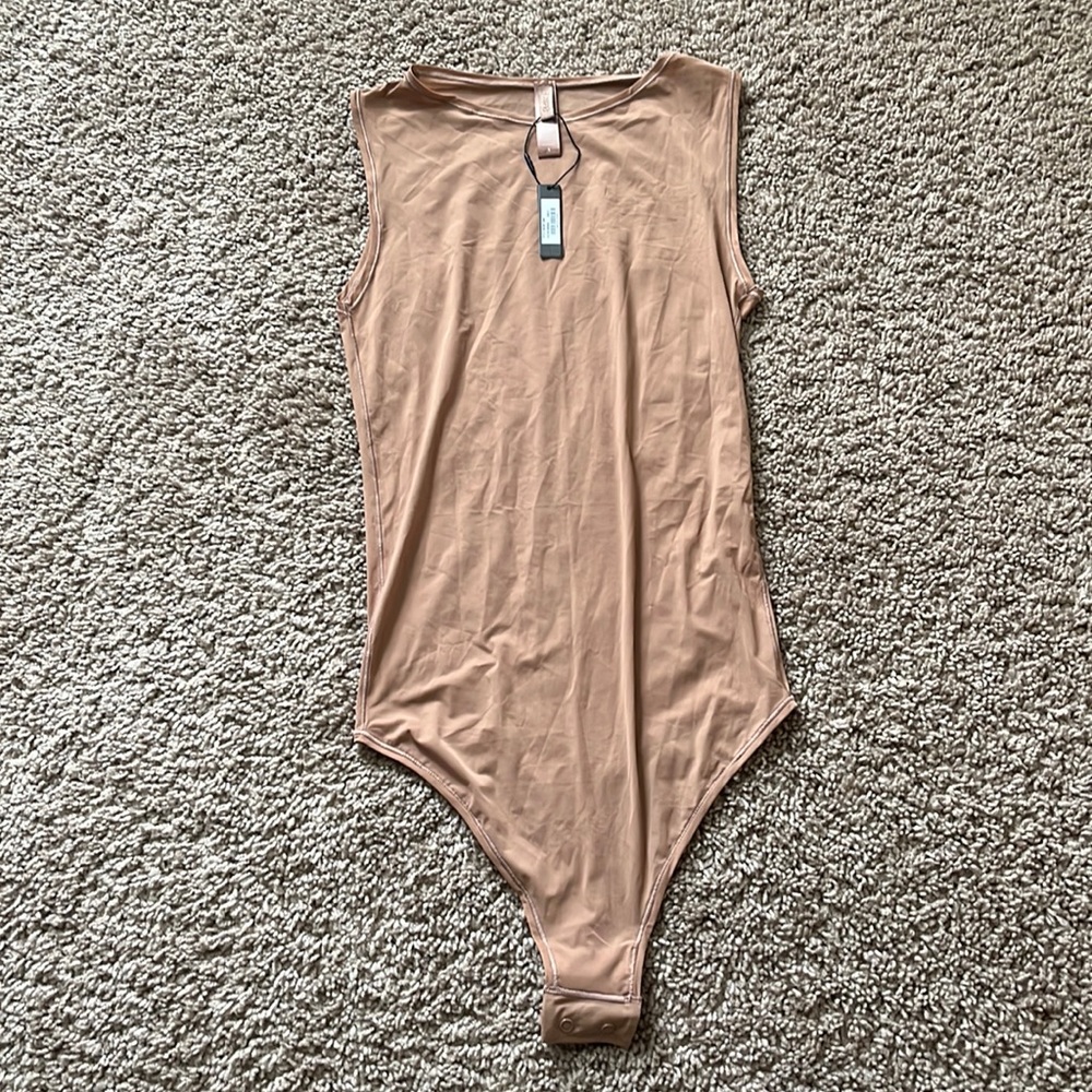 Skims. NWT size small high neck, one piece thong bodysuit.